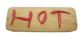 Red hot thai chilli peppers in a word hot on a cutting board Royalty Free Stock Photo