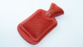 Red hot water bag for compressing Relieve muscle injuries or keep warm. Place it on a white background. A device for holding hot Royalty Free Stock Photo