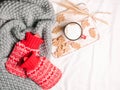 Red hot-water bottles on a bed. Royalty Free Stock Photo