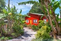 Red house along a beautiful tropical trail. Vacation and holiday concept