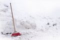 Red house broom on a pile of snow