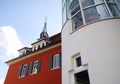 Building with red facade and green shutters and stairwell extension in white and semicircular Royalty Free Stock Photo