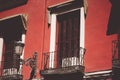 Red house exterior balconies Old building Wooden shutters. Architecture exterior Royalty Free Stock Photo