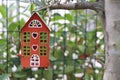 Red house hanging on the olive tree