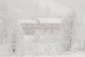 Red house in heavy snowfall Royalty Free Stock Photo