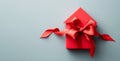 Red house-shaped gift with vibrant satin bow Royalty Free Stock Photo