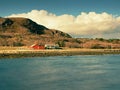 Red houses of the fishing village. Traditional red white building in small port, coastline of cold north sea Royalty Free Stock Photo