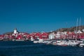 Red houses and white church with boats in village of Skaerhamn on the archipelago island of TjÃ¶rn in the west of Sweden