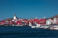 Red houses and white church with boats in village of Skaerhamn on the archipelago island of TjÃ¶rn in the west of Sweden