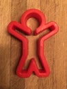 Red human figure, man on the wooden cutting board