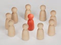 Red human figure surrounded by a circle of people. Leader Boss and leadership. Cooperation and teamwork. Royalty Free Stock Photo