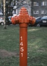 Red hydrant and green grass with white numbers closeup Royalty Free Stock Photo