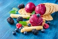 Red ice cream with berries, sorbet on wooden dark background Royalty Free Stock Photo