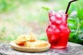 Red iced soft drink with corn pastry pies