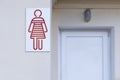 Red icon of a person denoting a female toilet on the street. Front view Royalty Free Stock Photo
