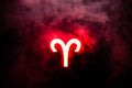 Red illuminated Aries zodiac sign with smoke