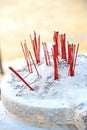 Red incense sticks in sand pot Royalty Free Stock Photo