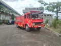Red indonesian firefighter engine standing idle in a side road