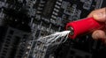 Red industrial battery shooting white lightning in hand held in front of blurred cpu board, composite photo Royalty Free Stock Photo