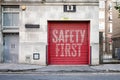 Red Industrial Garage Door With Large Safety First Warning Text Royalty Free Stock Photo