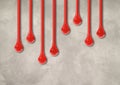 Red ink drops on light concrete wall. Horizontal wallpaper