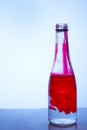 Red ink mixed with water in a glass bottle on a light background Royalty Free Stock Photo