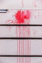 Red ink splashes on a wall