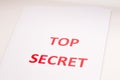 Red inscription TOP SECRET on a white sheet. Secrets and conspiracies. Archives of documents. Financial statements. Royalty Free Stock Photo