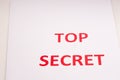 Red inscription TOP SECRET on a white sheet. Secrets and conspiracies. Archives of documents. Financial statements. Royalty Free Stock Photo