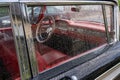 Red interior of an American classic car through the side window with many raindrops. Royalty Free Stock Photo