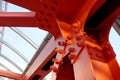 Red iron beams bolted on. Crossing the road, hanging bridge. Covered overhead pedestrian crossing with an iron structure Royalty Free Stock Photo