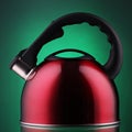 Red kettle over green background