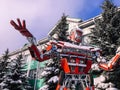 Red iron metal big strong dangerous fantastic, futuristic humanoid robot from a car with hands and head in winter
