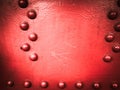 Red iron metal rough painted strong solid industrial wall with rivet holes and bolts. Background, texture Royalty Free Stock Photo