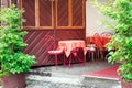 red iron table with chairs and a polka-dot tablecloth in an outdoor cafe. Royalty Free Stock Photo