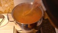 Over the shoulder stirring of home made Italian tomato sauce