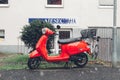 The red IVA Lux 50 scooter on a street in a german town