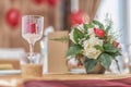 Red and ivory floral arrangement prepared for reception, wedding table with candle and setting, winter concept