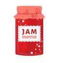 Red jam jar with checkered lid and label, strawberry or cherry preserve. Homemade fruit spread, canning and preserving Royalty Free Stock Photo