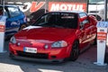 Red Japanese Honda CR-X Del Sol sports car parked at an exhibit