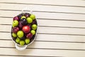 Red japanese plum and cherry in basket