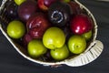 Red japanese plum and cherry in basket