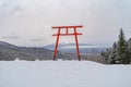 Red Japanese Torii pole, Fuji mountain and snow in Kawaguchiko, Japan. Forest trees nature landscape background in winter season Royalty Free Stock Photo