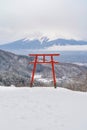 Red Japanese Torii pole, Fuji mountain and snow in Kawaguchiko, Japan. Forest trees nature landscape background in winter season Royalty Free Stock Photo