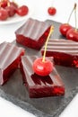 Red jelly dessert with gelatin and cherry on top Royalty Free Stock Photo