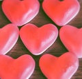 Red jelly hearts on wooden background