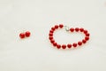 Red jewelry: bracelet and earrings with beads on a white background Royalty Free Stock Photo