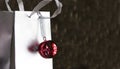 Red jingle bell on silver shopping bag