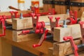 Red joiner clamps are fixed on product, gluing of boards