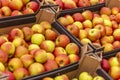 Red juicy apples in containers in a supermarket. Space for text